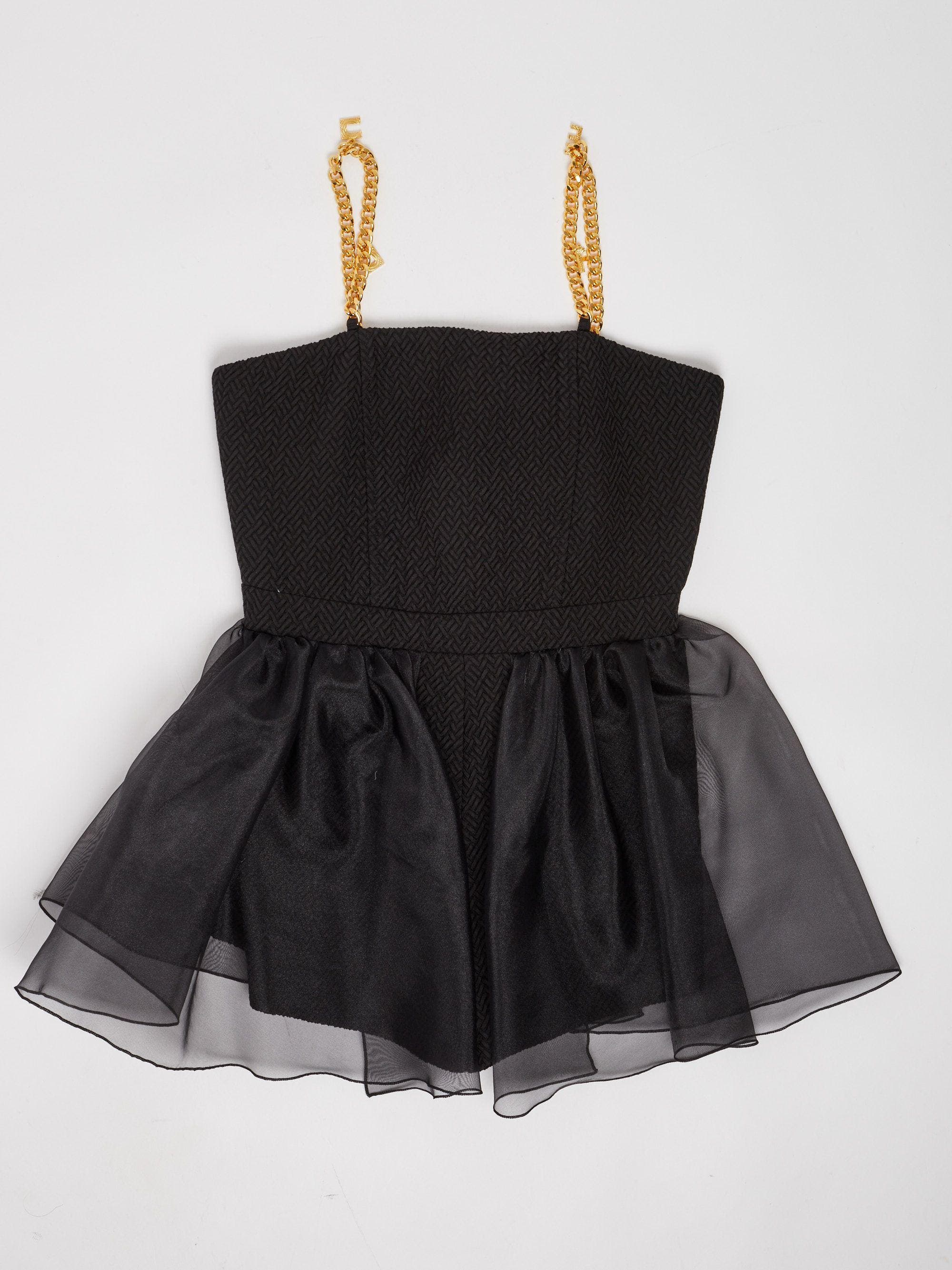 TUTA CON BRETELLE CON CHARMS 